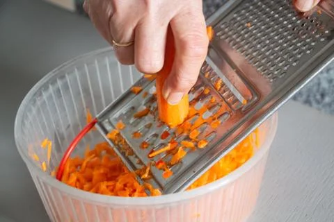 To grate carrot Stock Photos