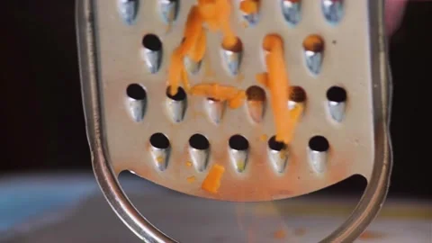 Grate the carrots on a grater in the kitchen Stock Footage 247450766