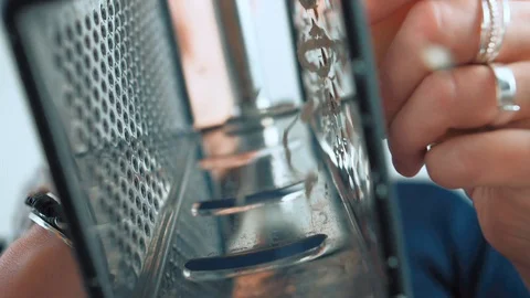 Grate cheese with a grater while cooking Stock Footage 129723345
