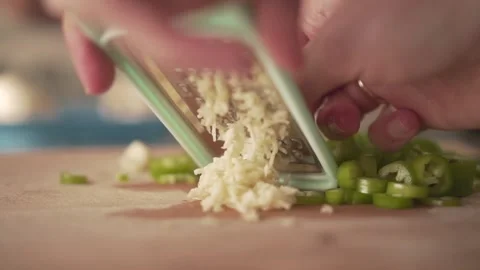 Grate garlic in the kitchen Stock Footage