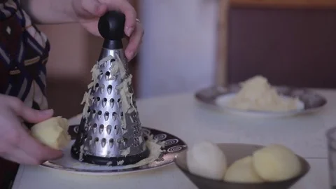 Grate the potatoes on a grater Stock Footage 71251632
