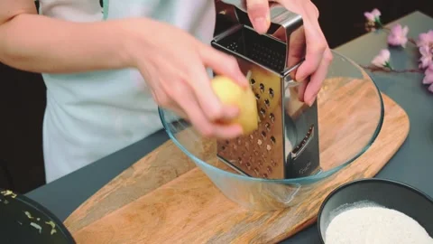 Grate raw potatoes on a coarse grater Stock-Footage 249595224