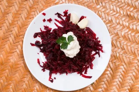 Grated beets in a plate on the table close-up Stock Photos