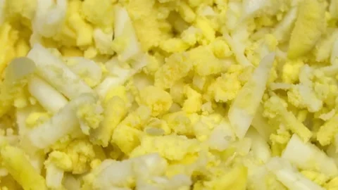 Grated boiled egg on grater in kitchen rotates around its axis on turntable. 動画素材 151208218