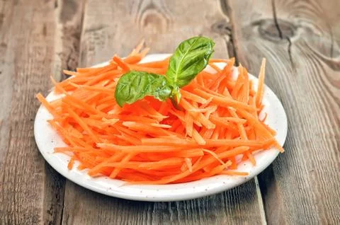 Grated carrot on rustic table Stock Photos