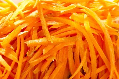 Grated carrots background. Stock Photos