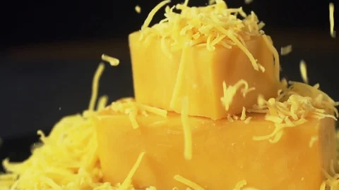 Grated cheddar cheese in the dark kitchen 動画素材 105367185