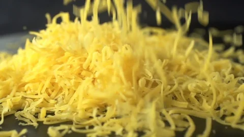 Grated cheddar cheese in the dark kitchen Video stock 105367192