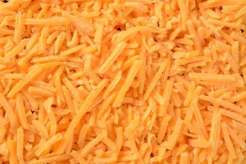 Grated cheddar cheese Stock Photos