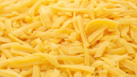 Grated cheddar cheese rotating top view 動画素材 136430514