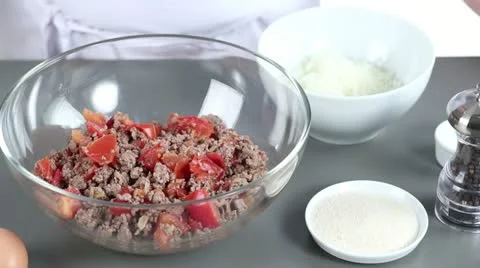 Grated cheese being added to a minced meat and tomato mixture Stock Footage 24671189