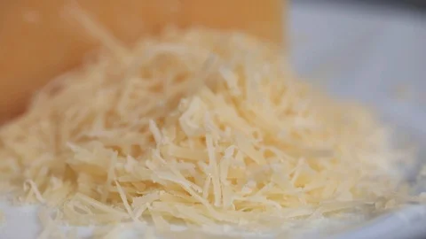 Grated cheese on a cutting board Stock Footage 103985366