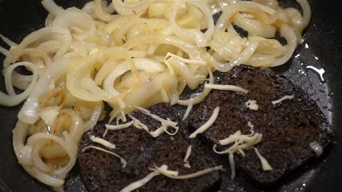 Grated cheese drops in slow motion on toasted and onions Stock Footage 126898584