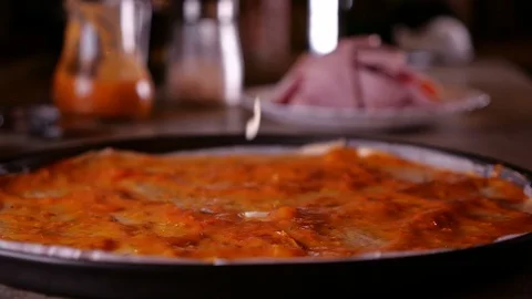 Grated cheese fall on pizza with sauce in baking pan  - slow motion 動画素材 101862521