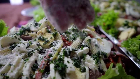 Grated cheese falling over Guatemalan fiambre plate as part of the final decorat Stock Footage 319001644