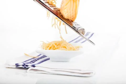 Grated cheese falling. Stock Photos