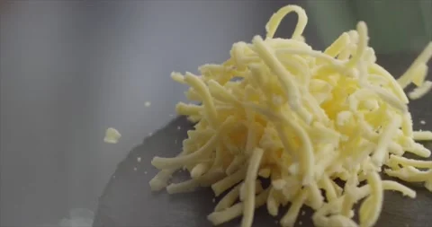 Grated cheese falls on a black surface Stock Footage 198146688