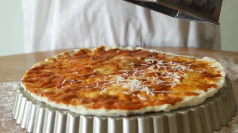 Grated cheese falls on the dough. Making pizza. Cheese is grated on the dough Stock Footage 315028727