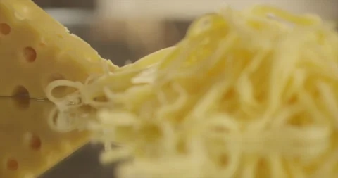 Grated cheese falls on a mirror surface Stock Footage 196971386