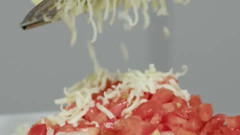 Grated cheese falls on tomato Video stock 165597829