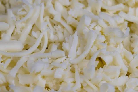 Grated cheese in large quantities at home Stock Photos