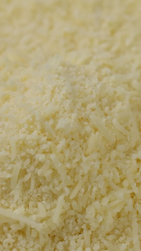 Grated cheese parmesan falling down on heap Stock Footage 277478787