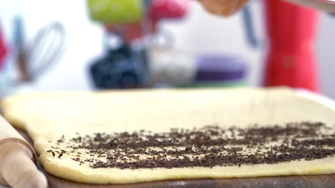 Grated chocolate is strew onto the dough Stock Footage 88693710
