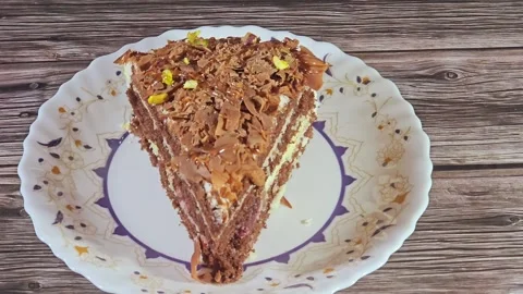 Grated chocolate triangular spongy cake piece Stock Footage 284937805