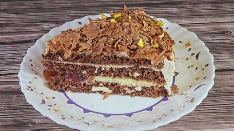 Grated chocolate triangular spongy cake piece Stock Footage 284937812