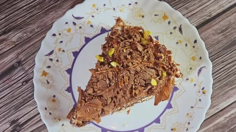 Grated chocolate triangular spongy cake piece Stock Footage 284937822