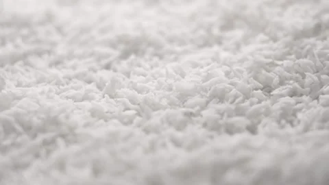 Grated coconut flakes falling in slow motion close up Stock Footage 239371243