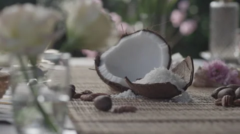 Grated coconut, piece of coconut and nuts on table Stock Footage 67021704