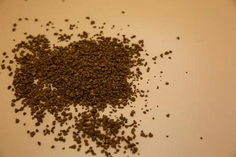 Grated coffee in orange background Stock Photos