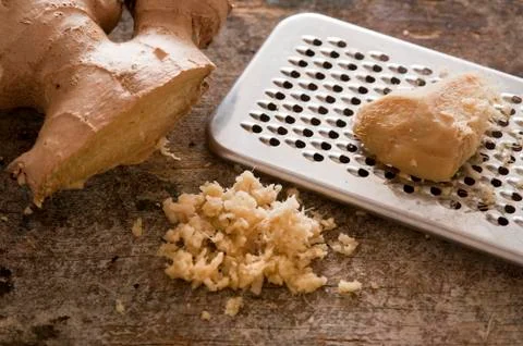 Grated ginger root on a rustic table Stock Photos