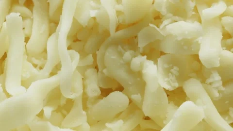 Grated mozzarella cheese extreme macro close up with a rotating camera moti.. Vídeo Stock 328594539