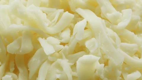 Grated mozzarella cheese extreme macro close up with a rotating camera moti.. Vídeo Stock 328594540