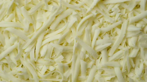 Grated mozzarella cheese top view. Sliding shot. 4K UHD video Stock Footage 153615271