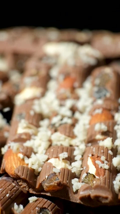 Grated nuts are sprinkled on nutty milk chocolate Stock Footage 292927692