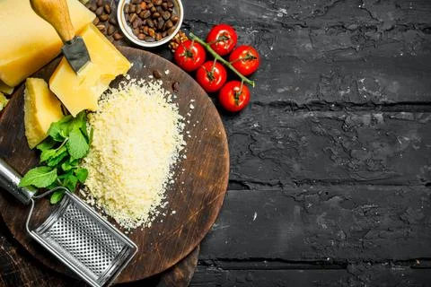 Grated Parmesan cheese with pine nuts, tomatoes and herbs. Stock Photos