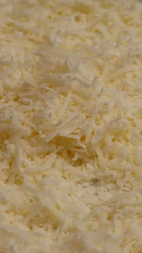 Grated parmesan cheese, rotation in circle. fine grano padano shreds, Turning. Stock Footage 323331809