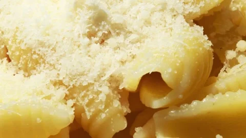 Grated Parmesan Cheese Sprinkled on Pasta Close Up Stock Footage 337322050