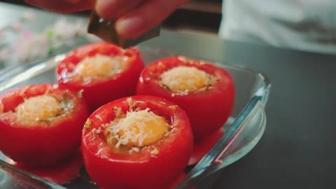 Grated parmesan falls on stuffed tomatoes Stock Footage 252468246