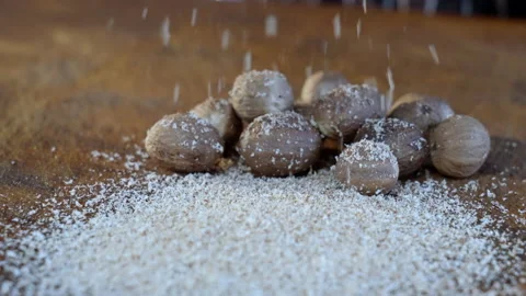 Grated spices. Grate nutmeg. Close up, slow motion of a man hand grating. Stock Footage 234589891