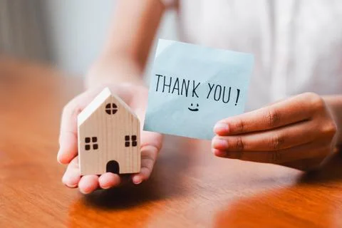 Grateful gesture thank you note with miniature house model home setting emo.. Stock Photos
