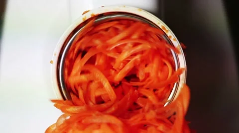Grates carrots into meat grinder Stock Footage 8600817