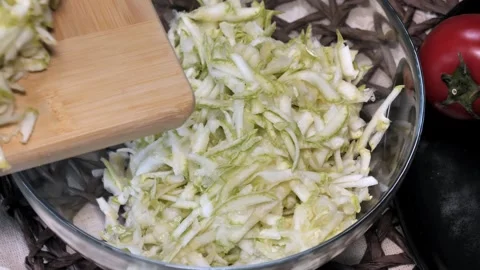 Grating and Pouring Zucchini into a Container Stock Footage 311268949