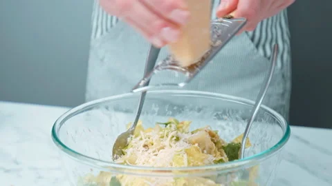 Grating and sprinkling parmesan cheese on freshly made Caesar Salad in 4K. Stock Footage 140769220
