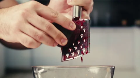 Grating boiled beetroot, beets on grater for russian soup borsch, heathty salad Stock Footage 309633077