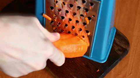 Grating carrot on a hand grater. Stock Footage 55718374