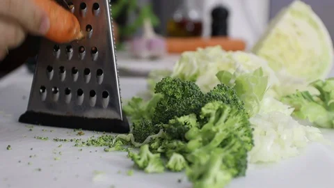 Grating Carrot over a white board. Stock Footage 129044519
